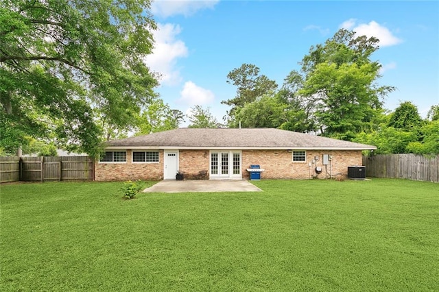 back of property featuring a fenced backyard, central air condition unit, a patio, french doors, and a lawn