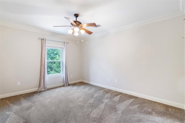 spare room with carpet, ceiling fan, ornamental molding, and baseboards