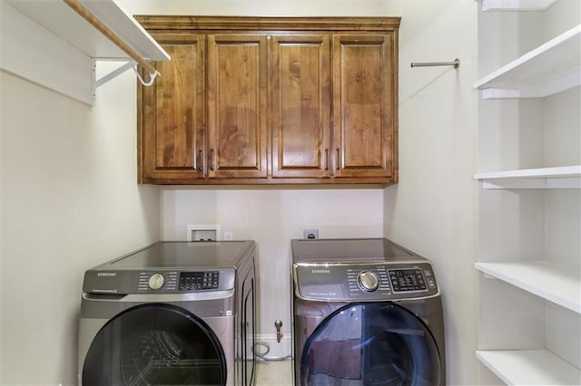 laundry area featuring cabinet space and washer and clothes dryer