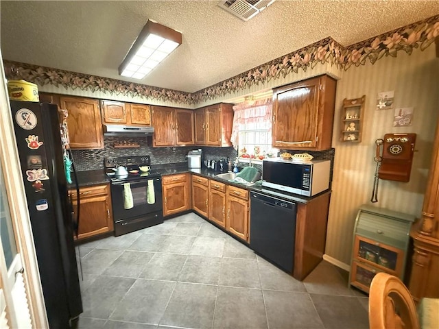 2053 Saulet Pl, Harvey, LA 70058 - kitchen featuring black appliances, dark countertops, under cabinet range hood, brown cabinets, and backsplash