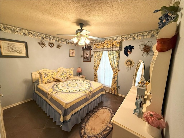 2053 Saulet Pl, Harvey, LA 70058 - bedroom featuring dark tile patterned flooring, a textured ceiling, and a ceiling fan