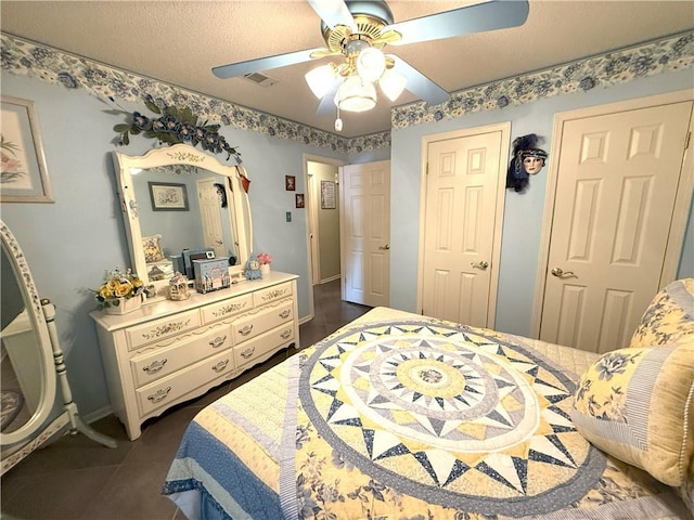 2053 Saulet Pl, Harvey, LA 70058 - bedroom featuring ceiling fan and dark tile patterned floors