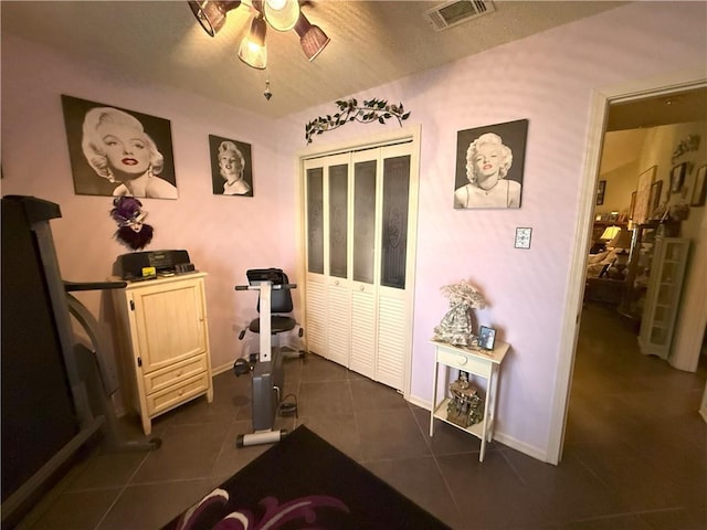 2053 Saulet Pl, Harvey, LA 70058 - workout room with a ceiling fan and dark tile patterned flooring