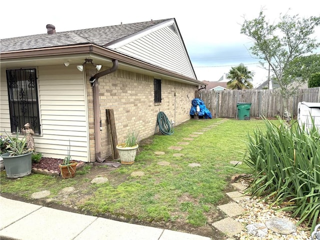2053 Saulet Pl, Harvey, LA 70058 - view of home's exterior with a shingled roof and brick siding