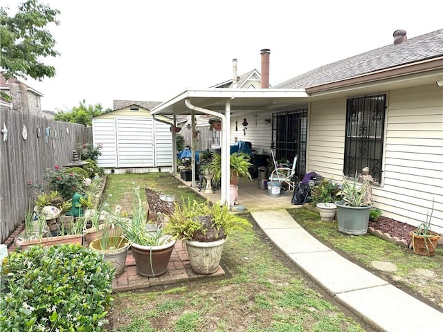 2053 Saulet Pl, Harvey, LA 70058 - fenced backyard with a storage unit and a patio area
