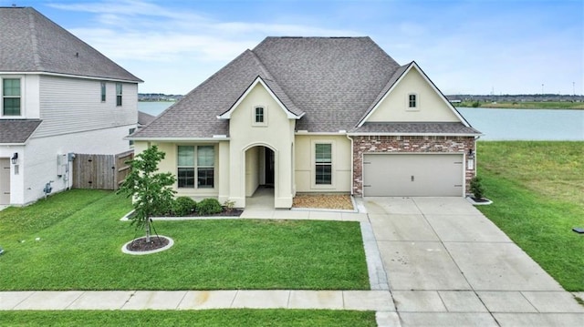 5520 Wake Reserve Rd, Slidell, LA 70461 - view of front of home featuring a garage, a front lawn, concrete driveway, a shingled roof, and stucco siding