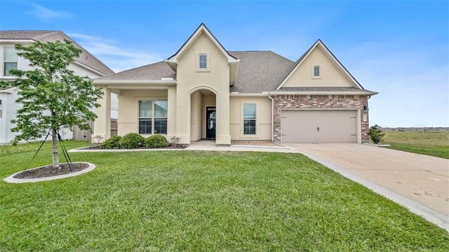 5520 Wake Reserve Rd, Slidell, LA 70461 - view of front facade with a front yard, concrete driveway, an attached garage, a shingled roof, and stucco siding