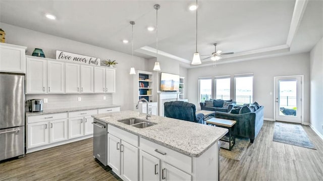 5520 Wake Reserve Rd, Slidell, LA 70461 - kitchen featuring ceiling fan, dark wood-style floors, a tray ceiling, a sink, and appliances with stainless steel finishes