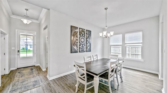 5520 Wake Reserve Rd, Slidell, LA 70461 - dining area featuring a chandelier, wood finished floors, and baseboards