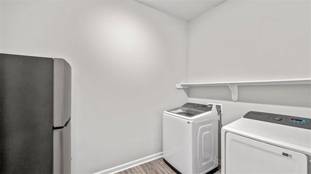 5520 Wake Reserve Rd, Slidell, LA 70461 - clothes washing area with laundry area, baseboards, washing machine and dryer, and wood finished floors