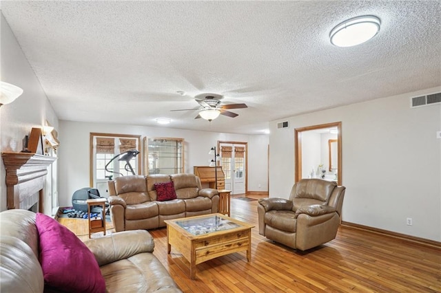 622 Pennsylvania Ave, Slidell, LA 70458 - living room with a textured ceiling, visible vents, and a ceiling fan