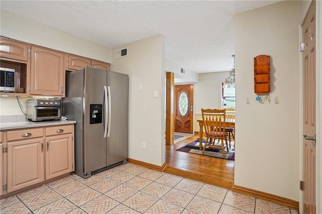 622 Pennsylvania Ave, Slidell, LA 70458 - kitchen with a toaster, stainless steel appliances, light countertops, visible vents, and a textured ceiling