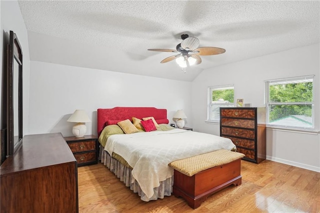 622 Pennsylvania Ave, Slidell, LA 70458 - bedroom featuring light wood-style flooring, vaulted ceiling, baseboards, a ceiling fan, and a textured ceiling