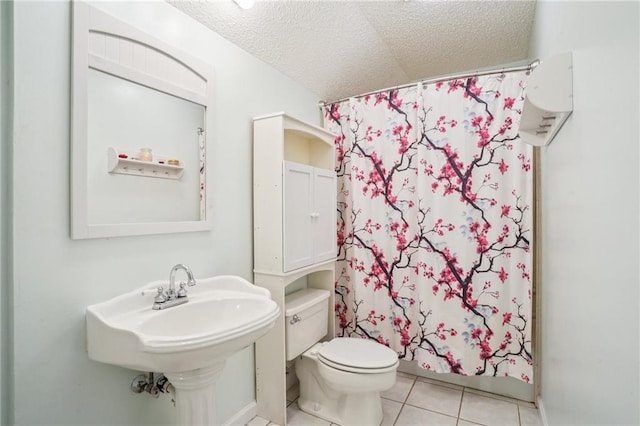 622 Pennsylvania Ave, Slidell, LA 70458 - full bathroom with tile patterned floors, a textured ceiling, toilet, and a shower with curtain