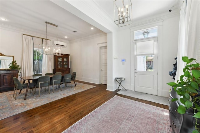 616 Cadiz St, New Orleans, LA 70115 - foyer entrance featuring ornamental molding, wood finished floors, an AC wall unit, and a notable chandelier