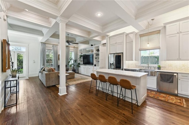 616 Cadiz St, New Orleans, LA 70115 - kitchen featuring a sink, appliances with stainless steel finishes, a breakfast bar, coffered ceiling, and open floor plan