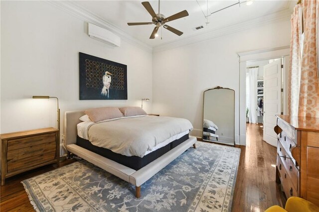 616 Cadiz St, New Orleans, LA 70115 - bedroom with a wall mounted air conditioner, a ceiling fan, visible vents, ornamental molding, and wood finished floors