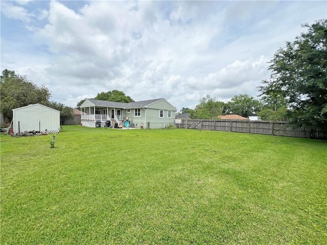 view of yard with an outdoor structure and a fenced backyard