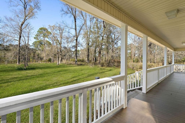 deck with a porch and a yard