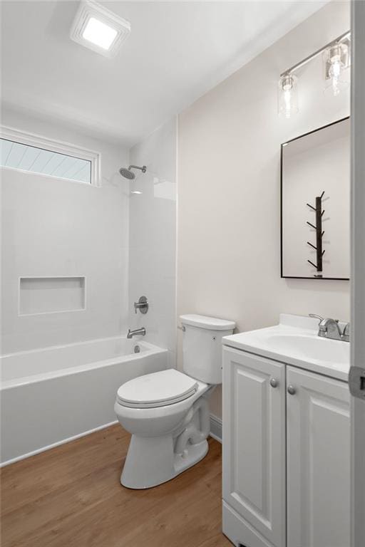 full bath featuring toilet, vanity, shower / tub combination, and wood finished floors
