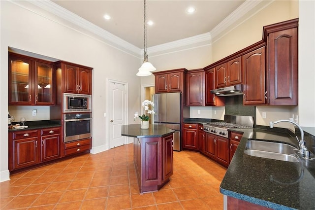 kitchen with light tile patterned floors, stainless steel appliances, under cabinet range hood, a sink, and pendant lighting