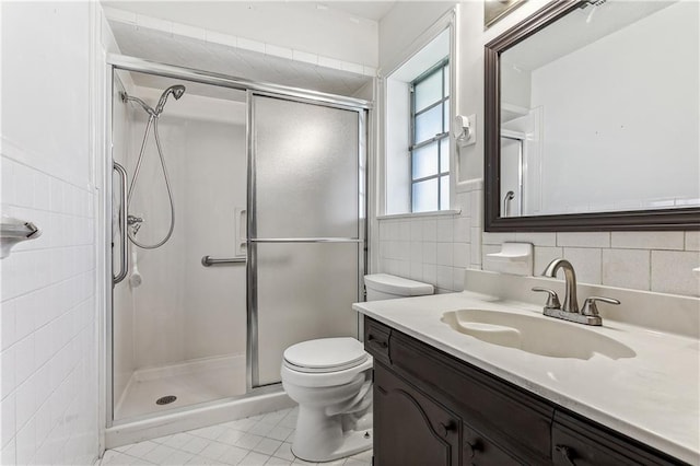 194 Sedgefield Dr, Harahan, LA 70123 - full bath with tile walls, vanity, a shower stall, toilet, and tile patterned flooring