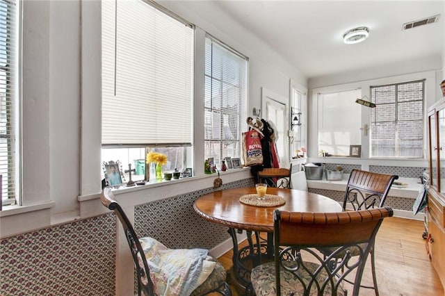 dining room featuring plenty of natural light, wood finished floors, and visible vents