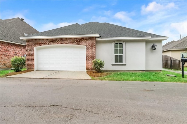 view of front of home with roof with shingles, concrete driveway, and a garage