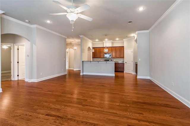 unfurnished living room featuring recessed lighting, arched walkways, and ceiling fan