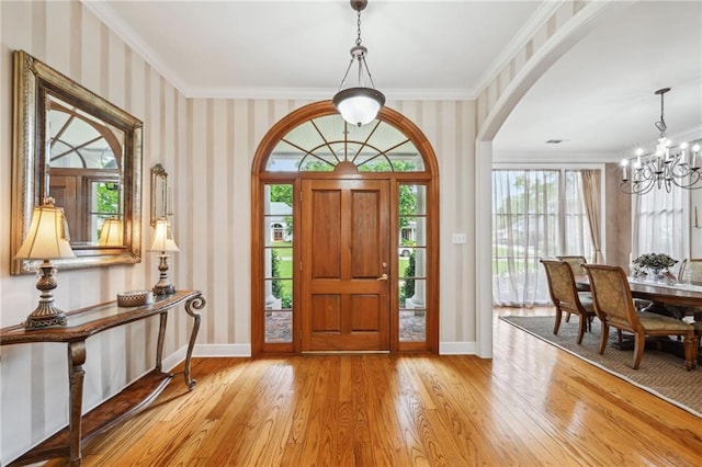 454 Rutherford Dr, Covington, LA 70433 - foyer with wallpapered walls, light wood-style floors, baseboards, a notable chandelier, and crown molding