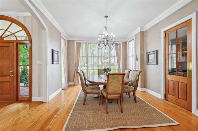 454 Rutherford Dr, Covington, LA 70433 - dining space featuring ornamental molding, light wood finished floors, an inviting chandelier, and plenty of natural light