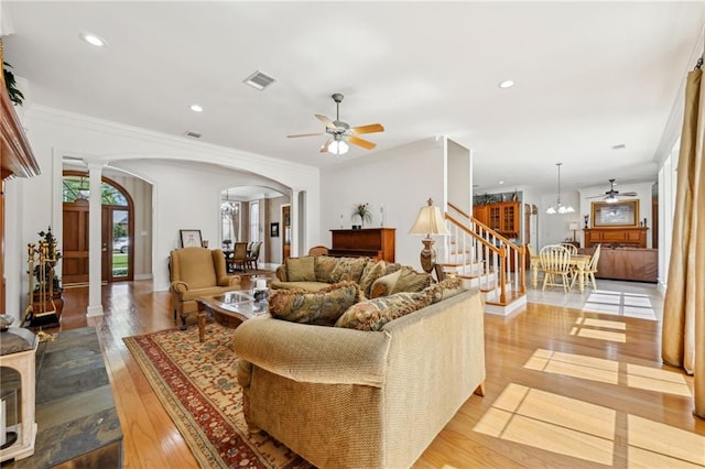454 Rutherford Dr, Covington, LA 70433 - living area featuring stairway, ceiling fan, hardwood / wood-style floors, arched walkways, and decorative columns