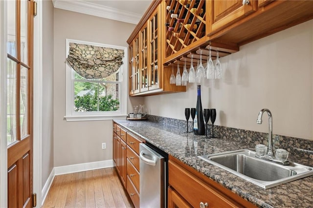 454 Rutherford Dr, Covington, LA 70433 - kitchen with stainless steel dishwasher, baseboards, brown cabinetry, and a sink