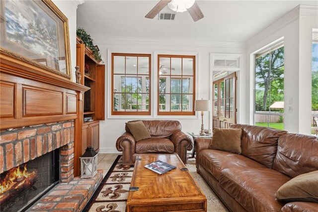 454 Rutherford Dr, Covington, LA 70433 - living area with a brick fireplace, crown molding, ceiling fan, and visible vents