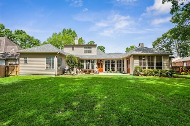 454 Rutherford Dr, Covington, LA 70433 - rear view of property featuring a chimney, fence, a sunroom, a patio area, and a lawn