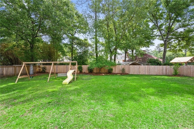 454 Rutherford Dr, Covington, LA 70433 - view of yard featuring a fenced backyard and a playground