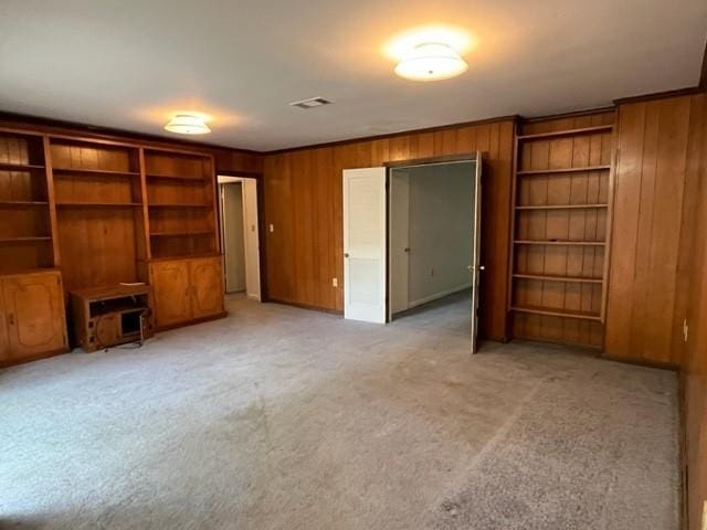 1736 11th St, Slidell, LA 70458 - unfurnished living room featuring wooden walls and light colored carpet