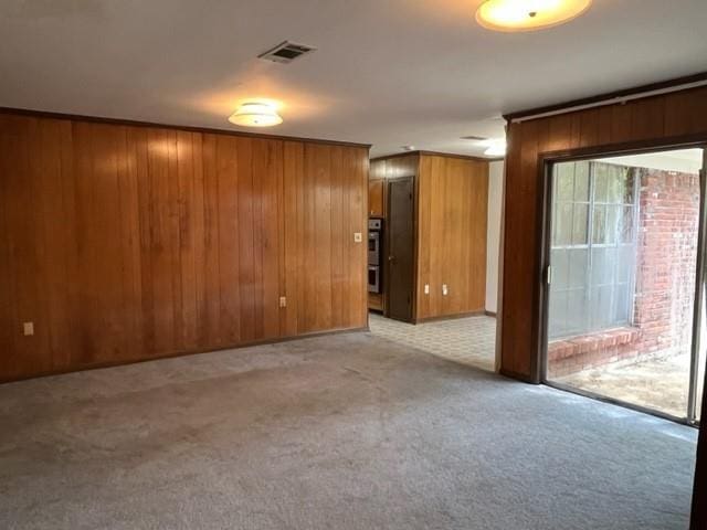 1736 11th St, Slidell, LA 70458 - spare room with wood walls and light carpet