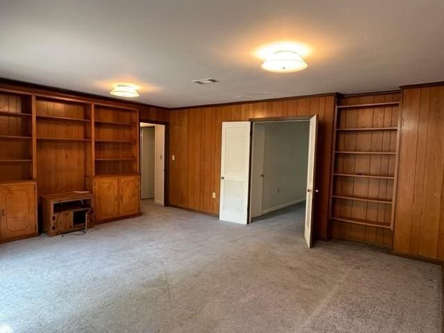 1736 11th St, Slidell, LA 70458 - unfurnished living room with wooden walls and light colored carpet