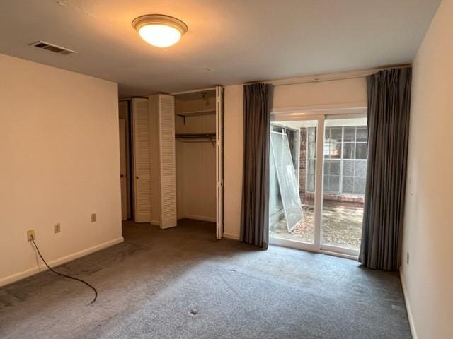 1736 11th St, Slidell, LA 70458 - unfurnished bedroom featuring carpet floors, multiple windows, access to outside, and baseboards