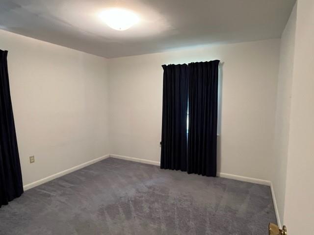 1736 11th St, Slidell, LA 70458 - empty room with carpet flooring and baseboards