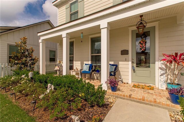 2329 Bradbury Pl, Covington, LA 70433 - property entrance with a porch and board and batten siding