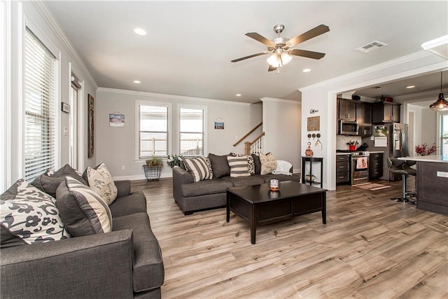 2329 Bradbury Pl, Covington, LA 70433 - living area featuring visible vents, ornamental molding, light wood-style flooring, and a healthy amount of sunlight