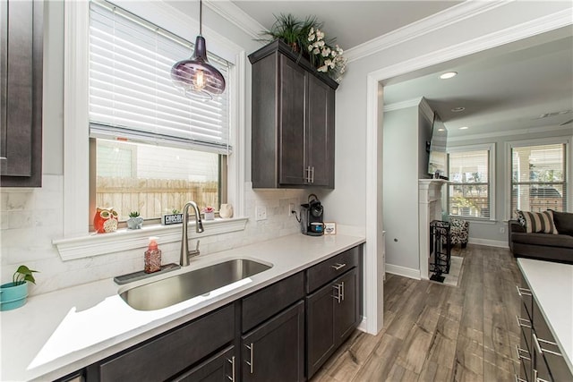 2329 Bradbury Pl, Covington, LA 70433 - kitchen with crown molding, a sink, dark brown cabinets, and tasteful backsplash