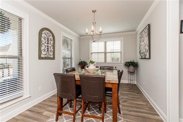 2329 Bradbury Pl, Covington, LA 70433 - dining area with dark wood-style flooring, baseboards, a chandelier, and ornamental molding