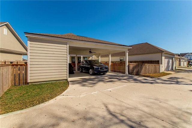 2329 Bradbury Pl, Covington, LA 70433 - garage with fence, ceiling fan, and concrete driveway