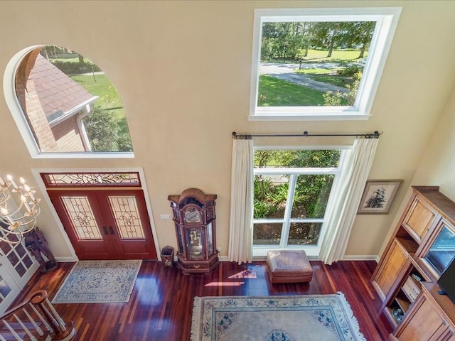 8063 Winners Cir, Mandeville, LA 70448 - entrance foyer with wood finished floors, a towering ceiling, and baseboards