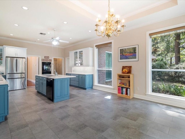 8063 Winners Cir, Mandeville, LA 70448 - kitchen featuring freestanding refrigerator, ornamental molding, light countertops, blue cabinetry, and recessed lighting