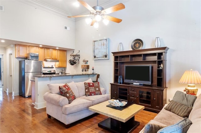 8416 Oak St Unit G, New Orleans, LA 70118 - living area with a ceiling fan, ornamental molding, wood finished floors, a towering ceiling, and recessed lighting