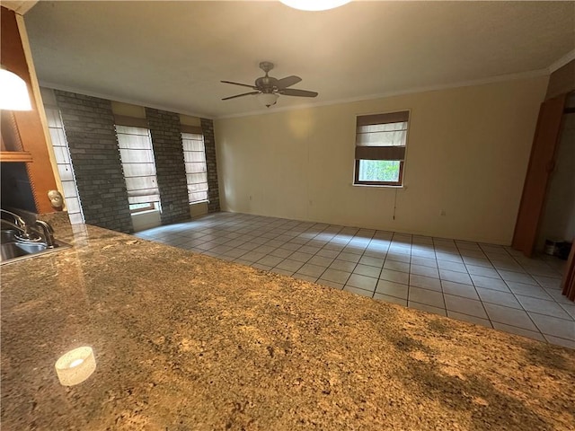 unfurnished room with crown molding, a sink, tile patterned flooring, and ceiling fan